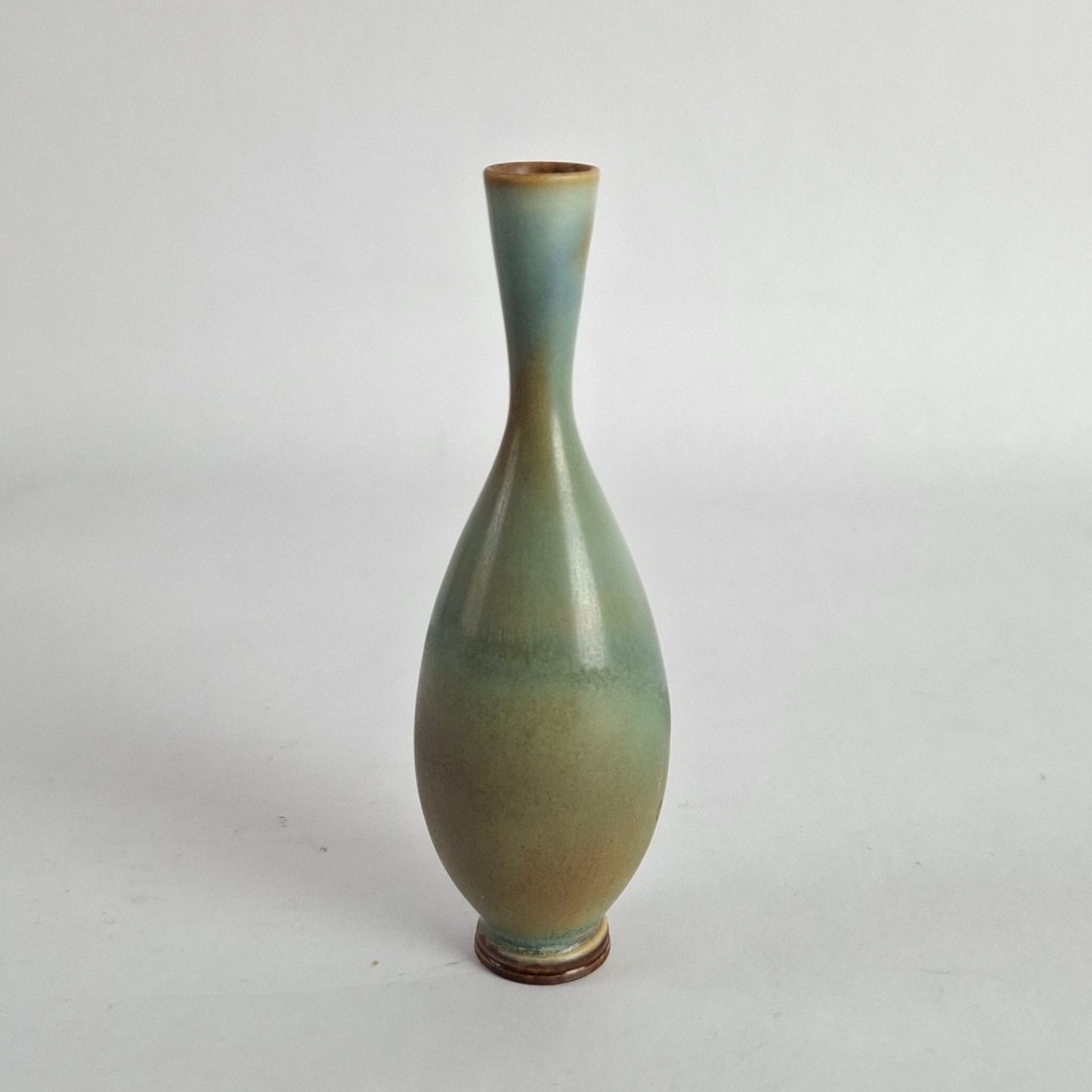 Stoneware miniature vase with a glaze of blues, greens, and browns colors.