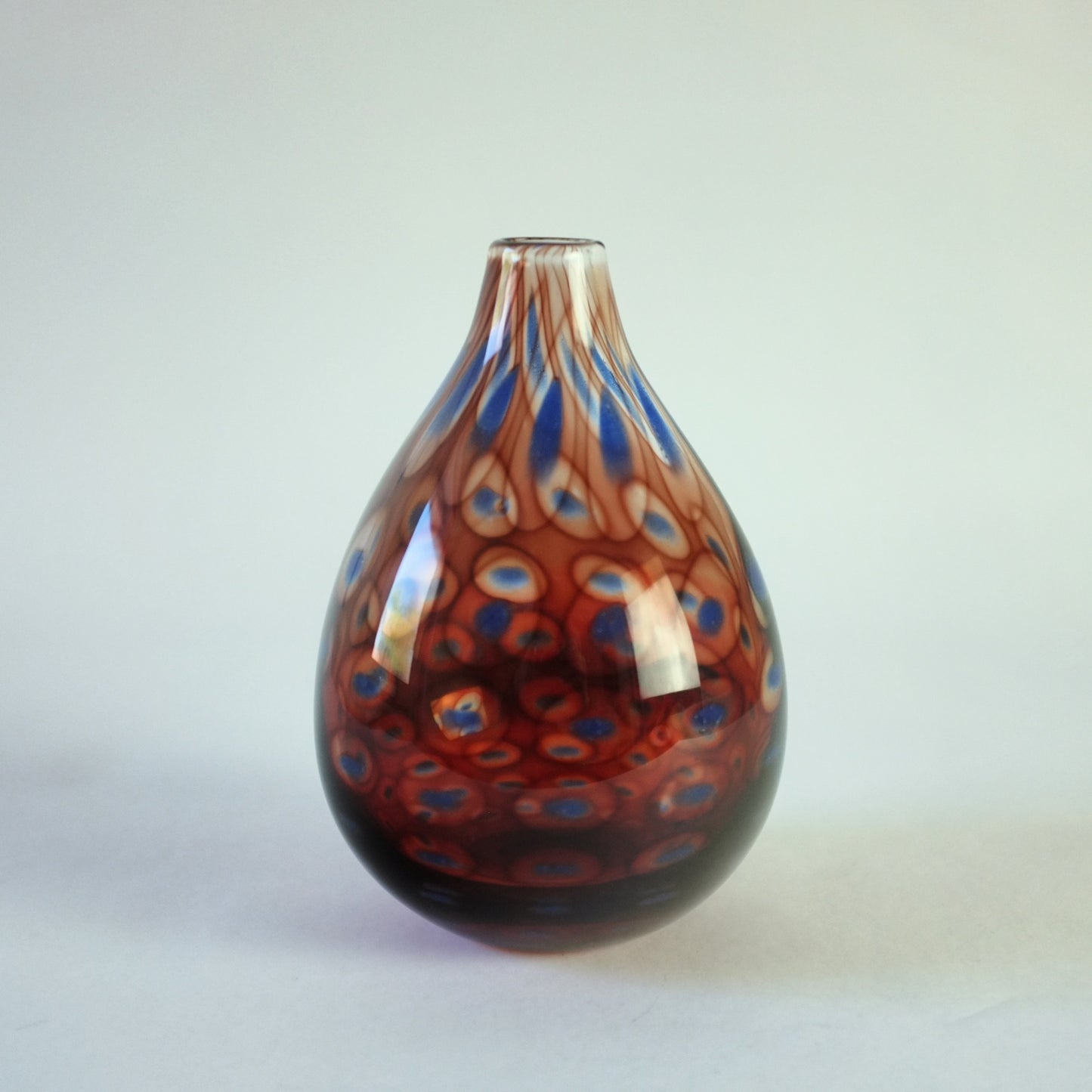 Colora vase with red and blue circle decoration.