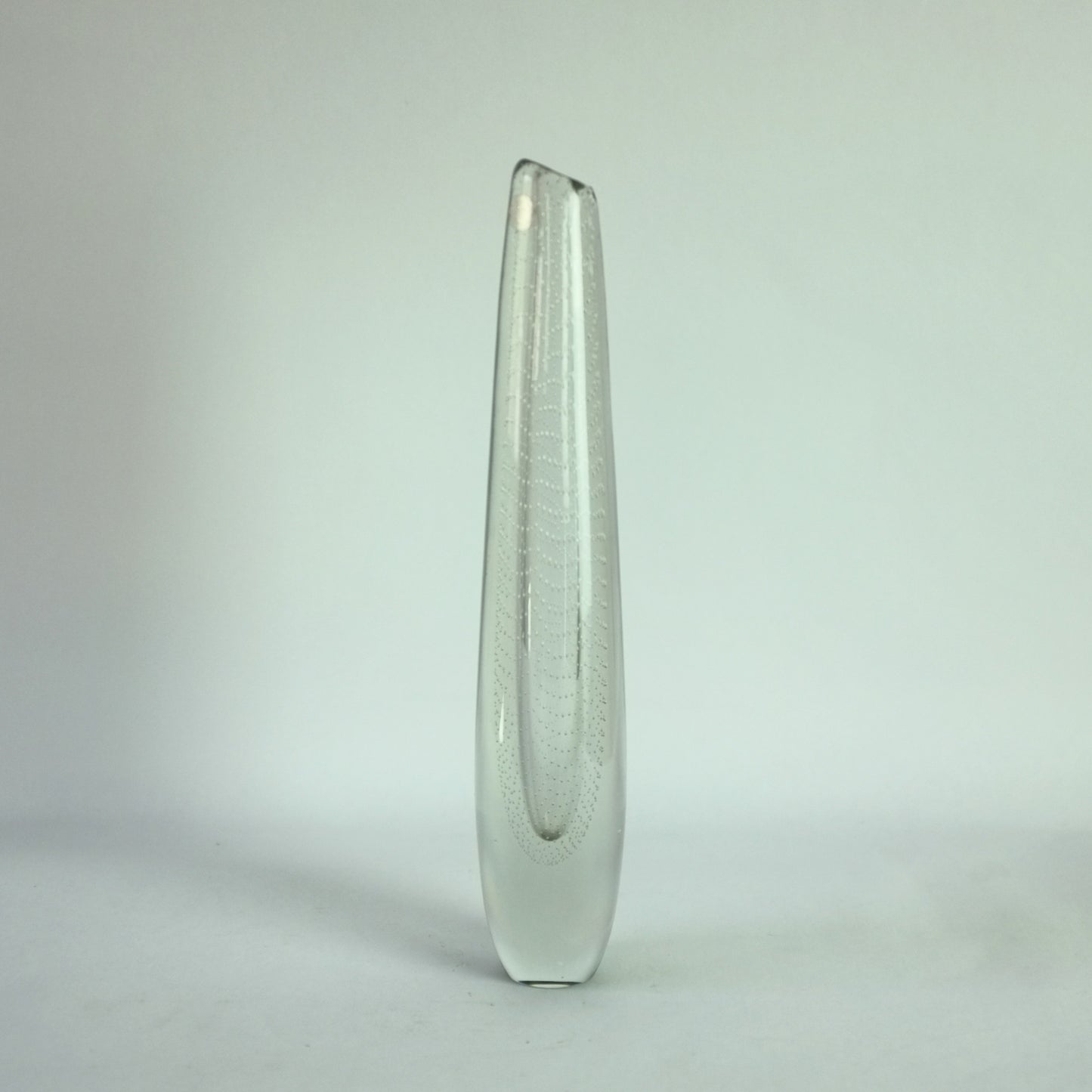 A clear glass vase with internal controlled bubble decoration.