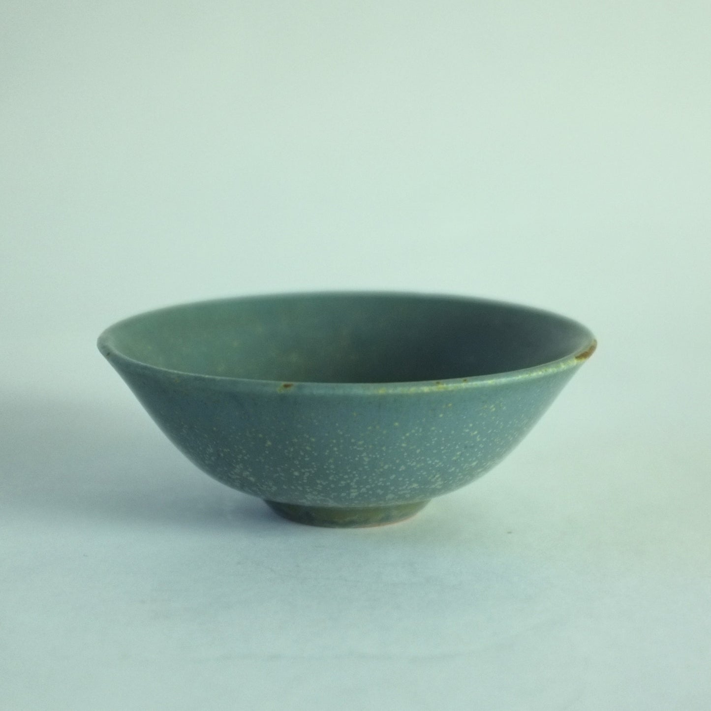A small stoneware bowl with mottled blue glaze.