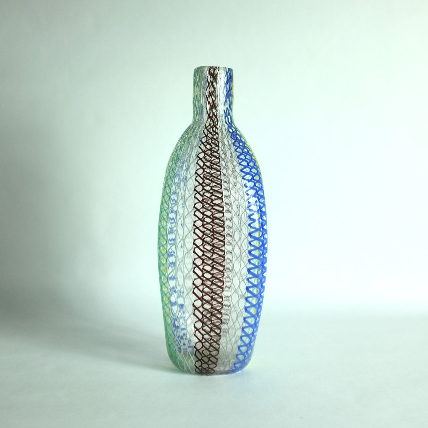 A tall shouldered multicolored glass vase with alternating vertical zanfirico canes designed by Dino Martens for Aureliano Toso, Murano, Italy.