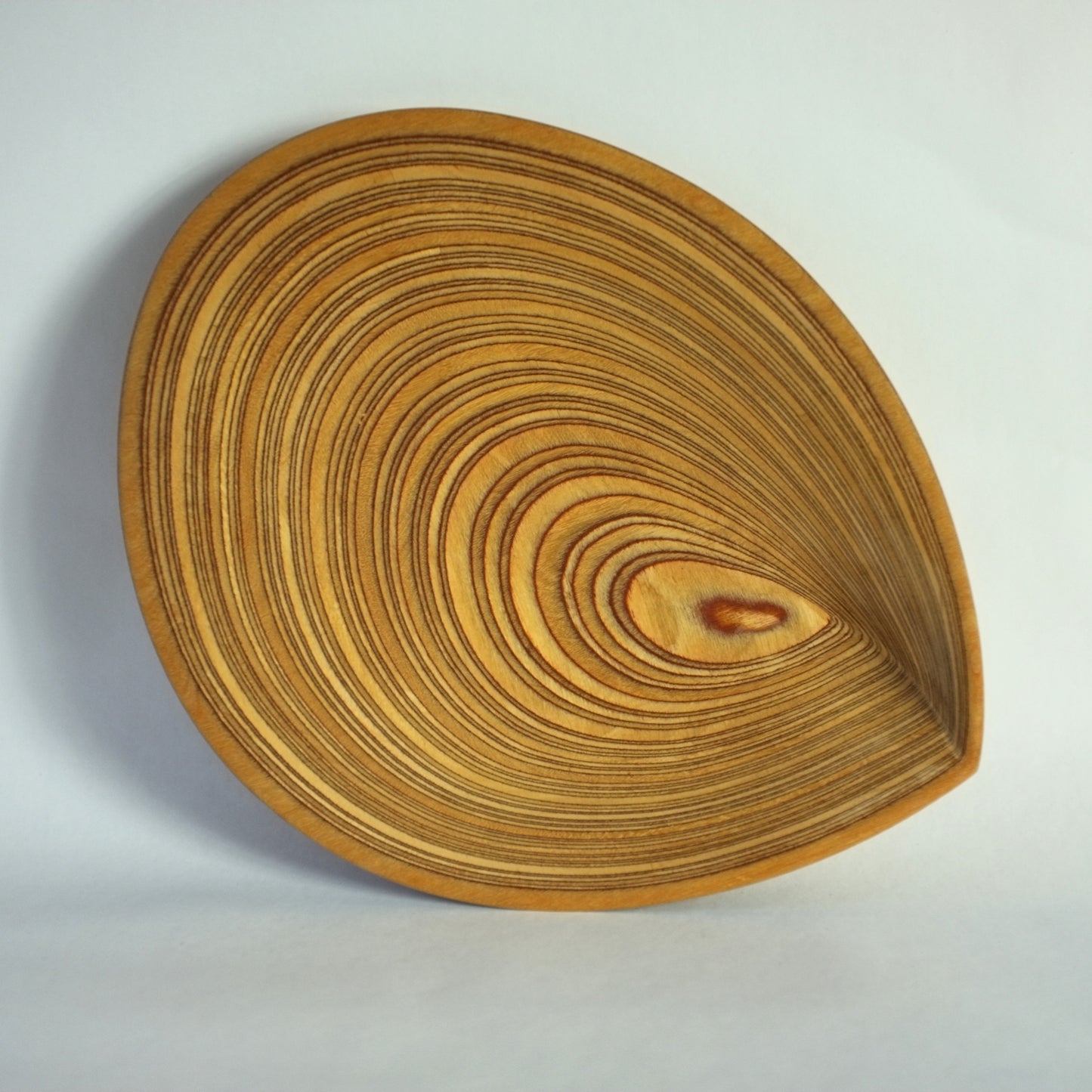 A carved laminated birch plywood dish designed by Tapio Wirkkala.