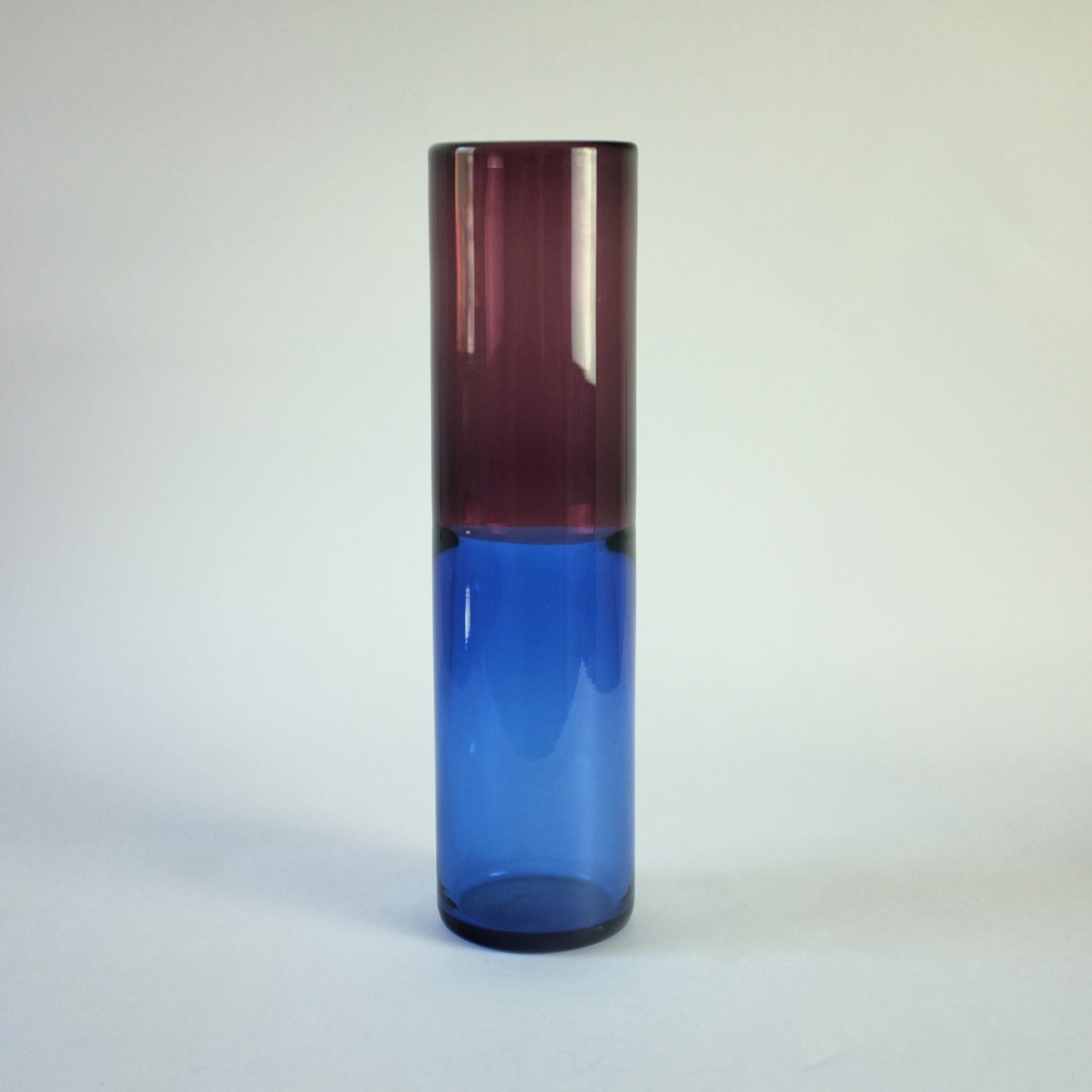A cylindrical vase of purple and blue glass in the incalmo technique.