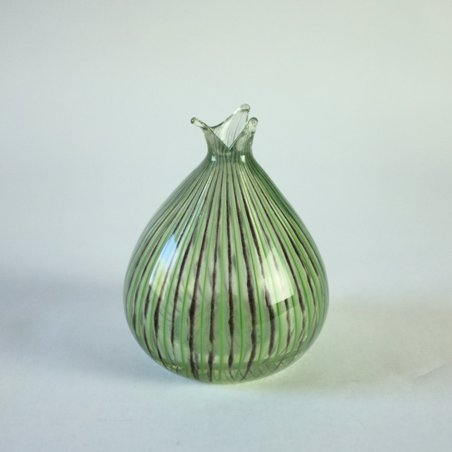 Glass vase of onion form with vertical green and purple stripes.