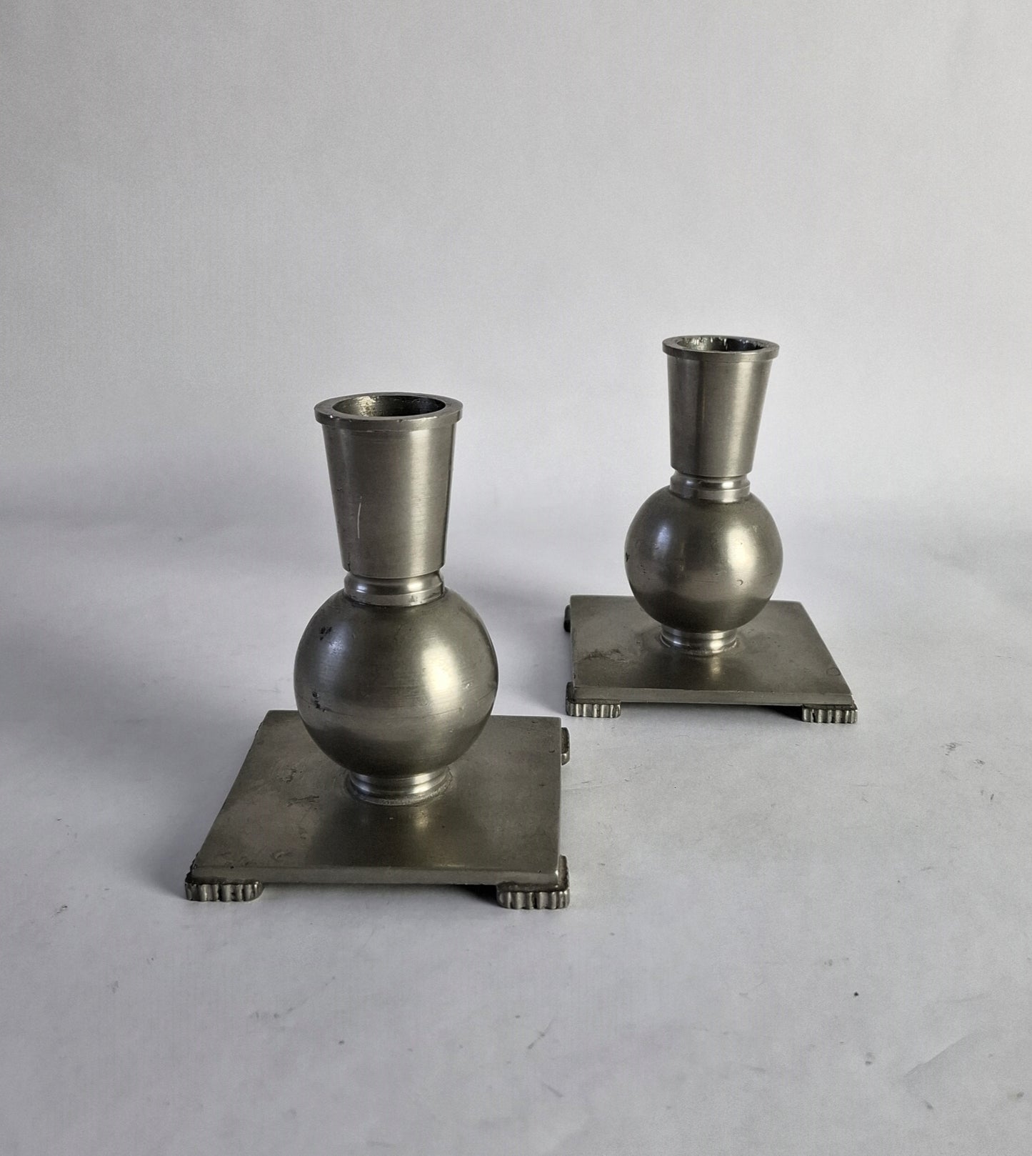 A pair of pewter candlesticks in Swedish grace style.