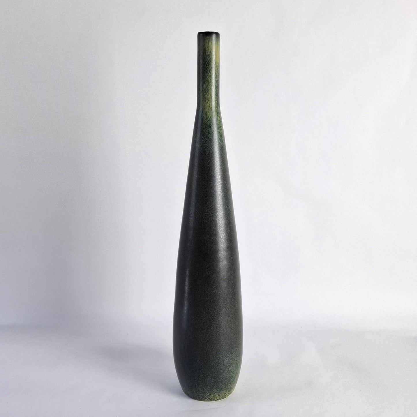 A tall, slender stoneware vase.
