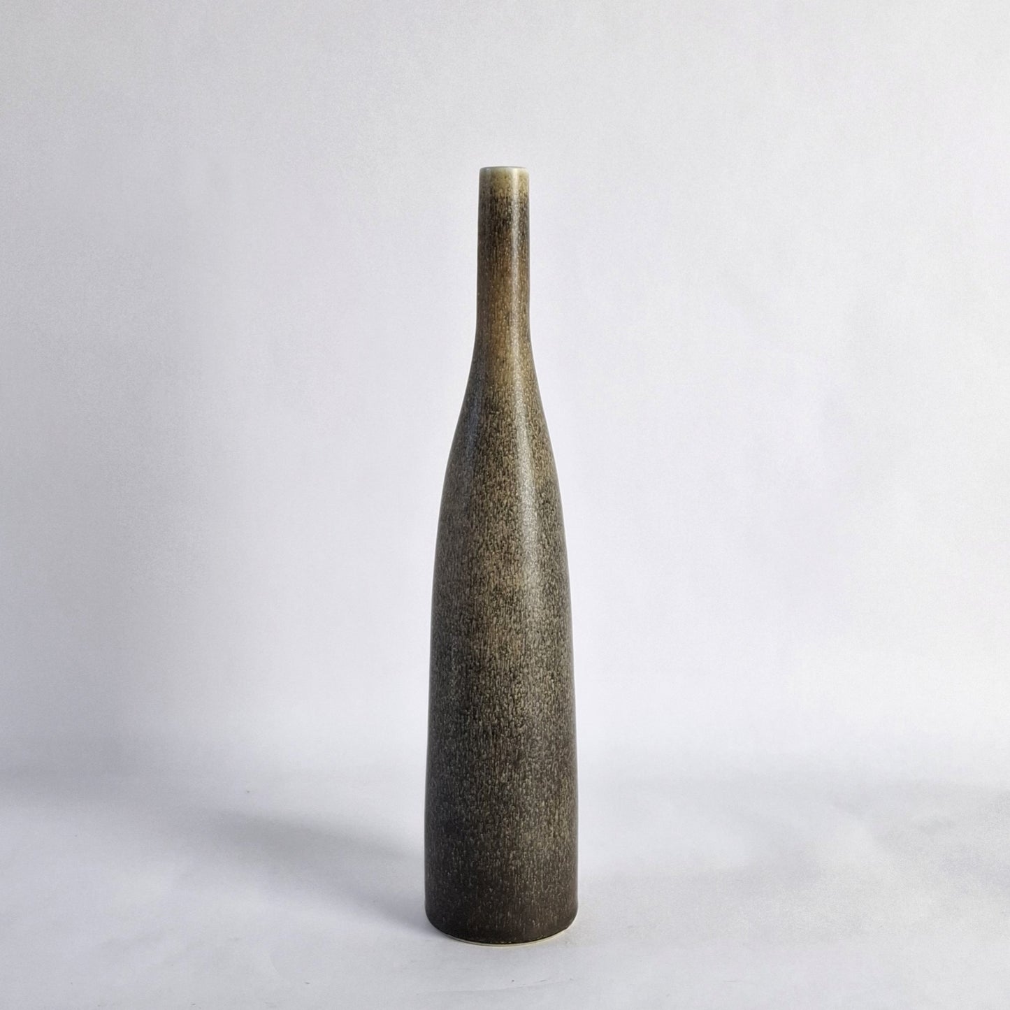 A unik stoneware vase with a mid-brown and grey haresfur glaze.