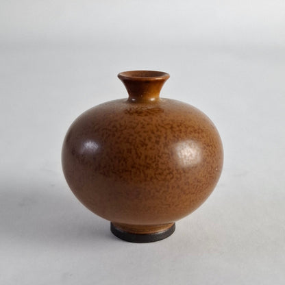 Miniature vase with a mottled brown glaze.
