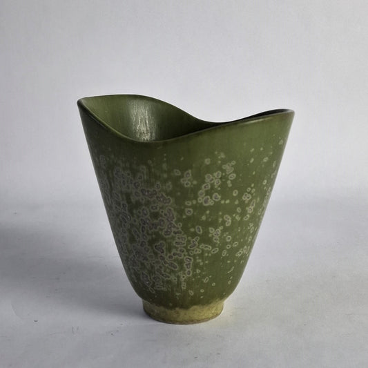 A green stoneware vase with pale violet spotting.