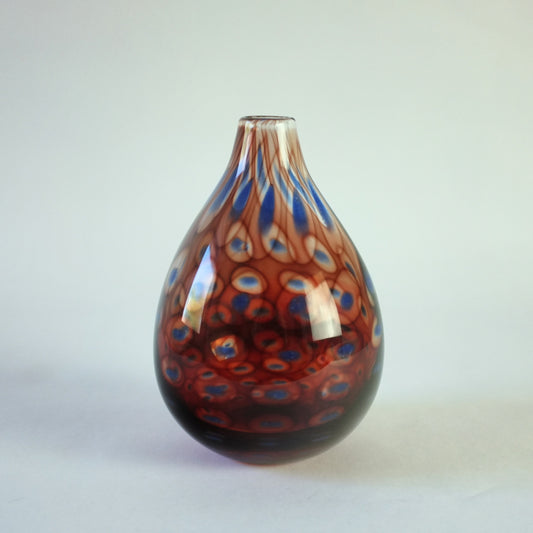 Colora vase with red and blue circle decoration.