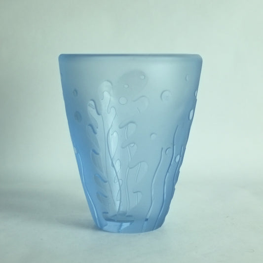 An acid etched blue glass vase with underwater seaweed designs in high relief.