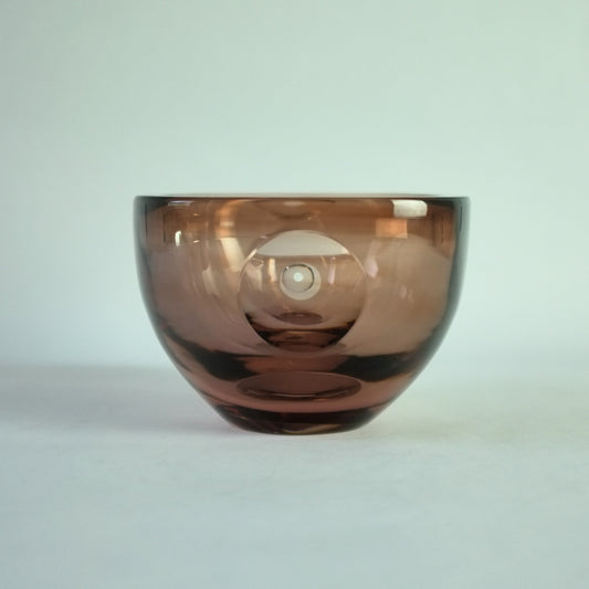 A square pinky brown glass bowl with a clear cut lens decoration.