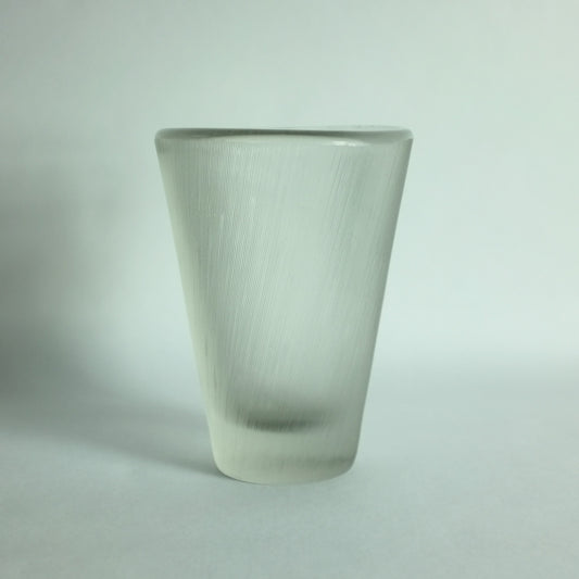 A large, heavy clear glass vase with a comb cut texture and tapering form, designed by Tapio Wirkkala for Iittala, Finland.
