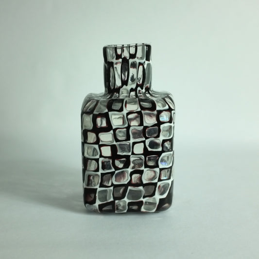 An 'Occhi' or 'eyes' vase with alternating black and white murrines by Tobia Scarpa for Venini glass company.