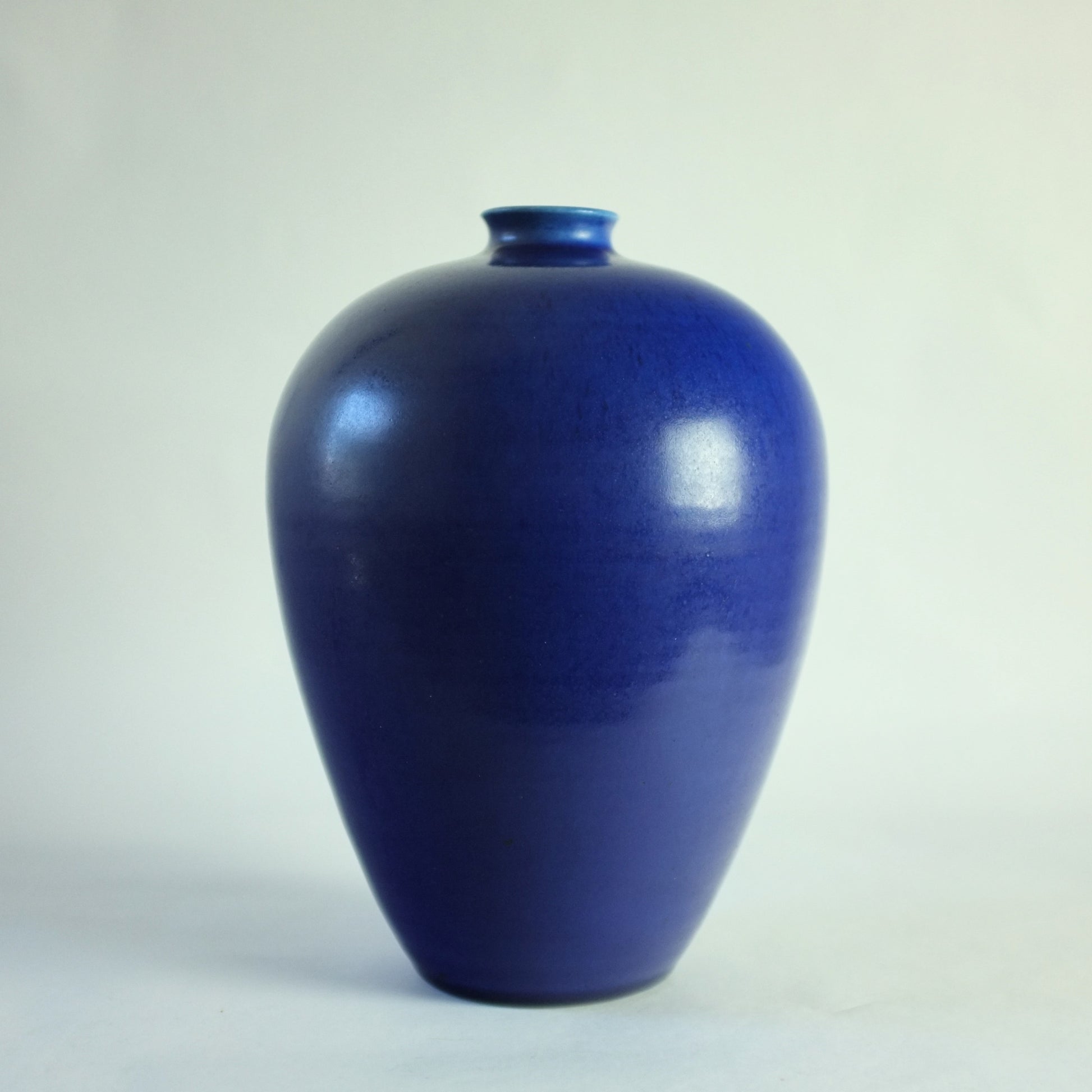 Stoneware vase with vivid blue glaze.