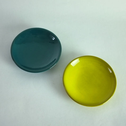 Two ceramic dishes, one in deep green and the other in yellow by  Jacques and  Dani Ruelland, France