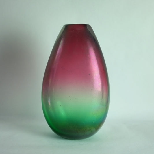 A large teardrop-shaped Murano glass vase with a red to green gradient and an iridescent finish.