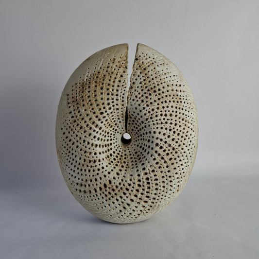 A stoneware vase of split form with spiralling incised decoration.background.