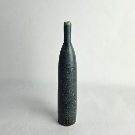A stoneware vase with mottled blue glaze.
