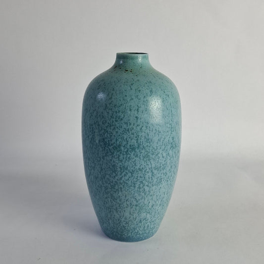A stoneware vase with mottled blue and green glaze.