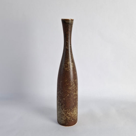 A tall stoneware vase with mottled brown glaze.