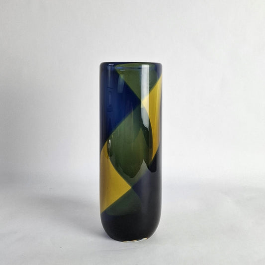 A cylindrical glass vase with a wide banded spiral design in blue and yellow.