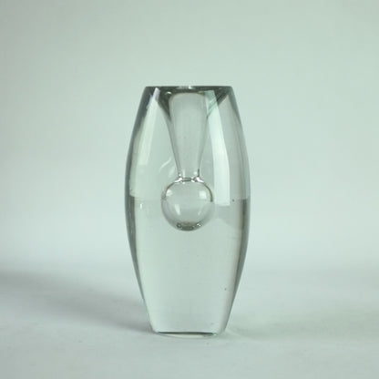 A clear glass vase with a waisted form with steam blown internal bubble.