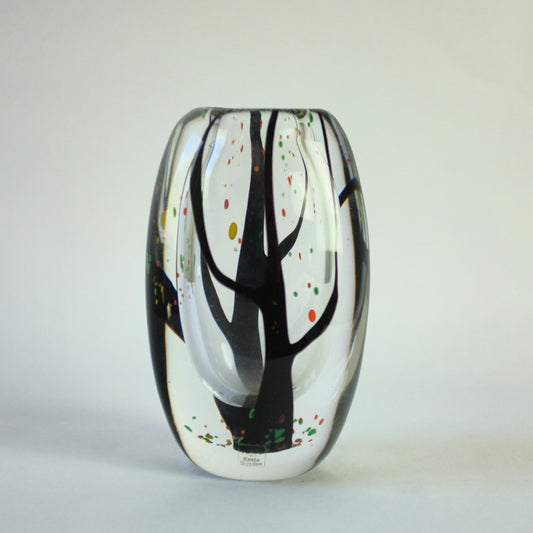 A glass vase with classic autumn leaves falling from two internally decorated trees.